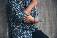 Free man in a blue shirt adjusting his sleeve, public domain people CC0 photo.