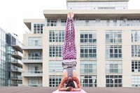 Free woman doing yoga pose on city rooftop building photo, public domain sport CC0 image.