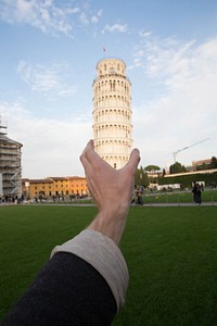 Hand over leaning tower. A classic tourist pose and picture.