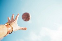 Free man throwing basketball in air photo, public domain sport CC0 image.