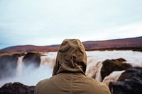 A person truly stunned by the scenery. The high waterfalls of Iceland, free public domain CC0 photo.