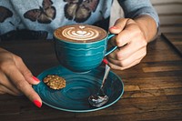 Free woman holding coffee in blue porcelain mug photo, public domain beverage CC0 image.