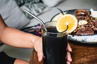 Free black lemonade with a fresh lemon image, public domain drink CC0 photo.