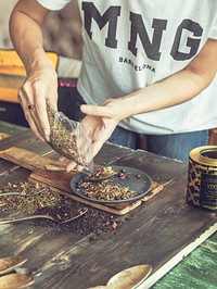 Woman dividing tea leafs. Free food image, public domain CC0 photo.