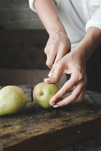 Free green apple being cut image, public domain fruit CC0 photo.