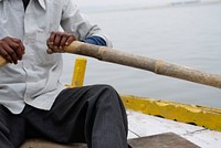 Man rowing a boat in the Ganges river. Free public domain CC0 photo.