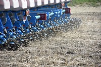 No-till planter with factory non-floating row cleaners and Schlagle closing wheels. Planting no-till corn into barley stubble on Brian Kindsfather's farm near Laurel, MT. Yellowstone County. May 2018. Original public domain image from <a href="https://www.flickr.com/photos/160831427@N06/40844898633/" target="_blank" rel="noopener noreferrer nofollow">Flickr</a>