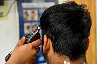 MEDITERRANEAN SEA. Ship's Serviceman Seaman Alijah Parkerhardison gives Umar Khan, a Military Sealift Command civil service mariner, a haircut aboard the Blue Ridge-class command and control ship USS Mount Whitney (LCC 20) April 16, 2018.