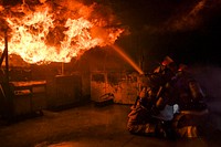 U.S. Sailors assigned to aircraft carrier USS Nimitz (CVN 68) and Arleigh Burke-class destroyer USS Momsen (DDG 92) practice firefighting skills and techniques by battling a simulated fire at the Bremerton International Emergency Services Training Center in Bremerton, Washington, March 22, 2018.