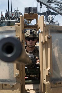 U.S. Marine Corps Lance Cpl. Evan Bultemeier, a machine gunner with Battalion Landing Team 3/1, 13th Marine Expeditionary Unit (MEU), provides security with an M2A1 machine gun aboard the Whidbey Island-class amphibious dock landing ship USS Rushmore (LSD 47) at sea, April 30, 2018.