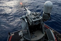 A Mark 38 machine gun system fires during a live-fire exercise on the flight deck of the Navy&#39;s forward-deployed aircraft carrier, USS Ronald Reagan (CVN 76) in the Philippine Sea July 11, 2018.