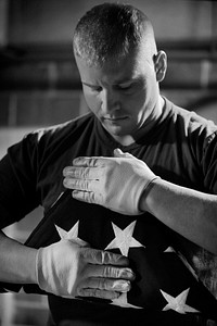 Lance Cpl. Bradley Young, a Marine Corps body bearer, finishes folding a funeral flag during a practice funeral Nov. 25, 2009.