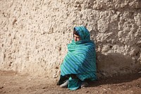 A child watches as U.S. Marines with Lima Company, 3rd Battalion, 4th Marine Regiment patrol during Operation Cobra's Anger in Now Zad, Afghanistan, Dec. 10, 2009.