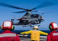 U.S. Sailors assigned to the San Antonio-class amphibious transport dock USS Anchorage (LPD 23), signal an AH–1Z Viper helicopter, attached to Marine Light Attack Helicopter detachment of Marine Medium Tiltrotor Squadron (VMM) 166, on the flight deck during composite training unit exercise (COMPTUEX) in the Pacific Ocean May 31, 2018.