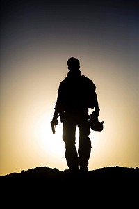 A U.S. Soldier with the 3rd Cavalry Regiment stands on a mound before taking part in a handgun night fire range near the Iraqi-Syrian border, June 21, 2018.