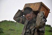 U.S. Marine Corp Lance Cpl. Preston Lea, assigned to Fleet Anti-terrorism Security Team (FAST) Company Europe, carries a box of ammunition to the firing range in Sierra Del Retin, Spain, Jan. 26, 2010, during Exercise Lisa Azul. Lisa Azul is a bi-lateral training exercise that promotes partnership and maritime security while improving a cultural understanding between Spain and the United States.