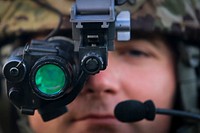 U.S. Army National Guard Staff Sgt. John Scott from Charlie Company, 1st Battalion, 114th Infantry Regiment, prepares his night vision googles for a nighttime air assault training mission on Joint Base McGuire-Dix-Lakehurst, N.J., July 18, 2018.