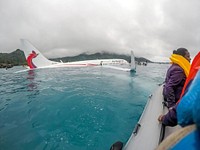 U.S. Sailors assigned to Underwater Construction Team (UCT) 2 assist local authorities in rescuing the passengers and crew of Air Niugini flight PX56 to shore following the plane ditching into the sea on its approach to Chuuk International Airport in the Federated States of Micronesia, Sept. 28, 2018.