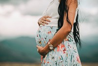 Pregnant lady holding belly. Free public domain CC0 photo.