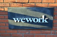 WeWork sign on brick wall, location unknown, October 18, 2018.