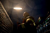 A New Jersey Department of Military and Veterans Affairs firefighter adjusts the lights on his fire engine prior to live burn training at the Anthony "Tony" Canale Training Center in Egg Harbor Township, N.J., Sept. 18, 2018. New Jersey state and Delaware Air National Guard firefighters teamed up with civilian instructors for the training that focused on fire suppression in small structures. (U.S. Air National Guard photo by Master Sgt. Matt Hecht). Original public domain image from Flickr