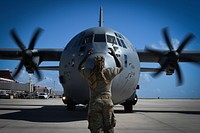 U.S. Air Force Staff Sgt. De'Angelo Sidney, an aerial port specialist with the 36th Contingency Response Group, marshals a C-130J Super Hercules at the Saipan International Airport, Saipan, Commonwealth of the Northern Mariana Islands, Nov. 28, 2018.