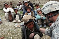 A U.S. Army medic treats an Afghan child for sunburn in the village of Meryanay in the Kherwar district of the Logar province of Afghanistan April 9, 2010.