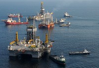 From foreground, the mobile offshore drilling unit (MODU) Development Driller II prepares to drill a relief well at the site of the Deepwater Horizon oil spill May 18, 2010, as the MODU Q4000 holds position directly over a damaged blowout preventer and the drillship Discover Enterprise continues to capture oil from the ruptured riser.