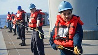 U.S. Navy Personnel Specialist 2nd Class Elida Villalobos, from Salem, Ore., heaves around line to Fleet Replenishment Oiler USNS Guadalupe (T-AO 200) during a replenishment-at-sea with U.S. 7th Fleet Flagship USS Blue Ridge (LCC 19) in the South China Sea, March 20, 2019.