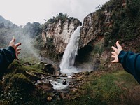 Traveler at waterfall. Free public domain CC0 photo.