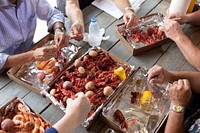 President Barack Obama, at left, eats boiled seafood with residents at Carmandelle's Live Bait and Boiled Seafood in Grand Isle, La., June 4, 2010.