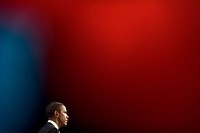 Framed through two flags, President Barack Obama takes questions during a press conference at the G20 Summit in Toronto, Canada, Sunday, June 27, 2010.