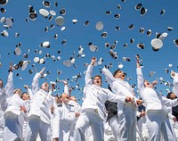 Midshipmen toss their covers in the air during the United States Naval Academy's Class of 2019 Graduation Day and Commissioning Ceremony.