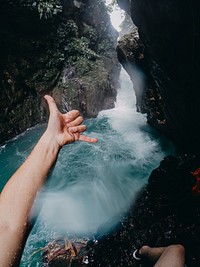 Man at waterfall. Free public domain CC0 photo.