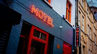 Motel neon sign on blue building in downtown. Original public domain image from Flickr