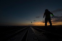 U.S. Navy Boatswain's Mate Seaman Cristian Martinez, from Anaheim, California, directs an MH-60S Sea Hawk helicopter on the flight deck aboard the guided-missile cruiser USS Vella Gulf (CG 72) in the Atlantic Ocean, July 10, 2019.