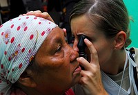 Air Force Capt. Tavalone Examines a Patient’s Eye