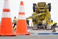 Civilian and active-duty Airmen assigned to the 773d Civil Engineer Squadron perform roadway maintenance, repaving, and replacement of concrete pads on the runway areas on Joint Base Elmendorf-Richardson, Alaska, Aug. 1, 2019. Civil engineer Airmen keep military facilities, utilities, roadways and runways in peak condition to support the diverse and challenging missions demanded of America's Air Force every day. (U.S. Air Force photo/Justin Connaher). Original public domain image from Flickr