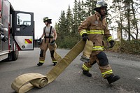 CE Airmen demonstrate fire protection capabilities at JBERU.S. Air Force fire protection specialists with the 673d Civil Engineer Squadron connect a fire hose while setting up for a fire protection capabilities demonstration at Joint Base Elmendorf-Richardson, Alaska, Sept. 6, 2019. Col. Patricia Csànk and Command Chief Master Sgt. Lee Mills, the JBER and 673d Air Base Wing commander and senior enlisted leader, respectively, participated in the demonstration to better understand the physical demands, gear requirements and conditions that might be encountered in an emergency situation. (U.S. Air Force photo by Alejandro Peña). Original public domain image from Flickr