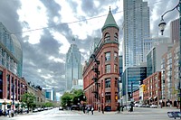 The Gooderham Building, also known as the Flatiron Building, is an historic office building at 49 Wellington Street East in Toronto, Ontario, Canada. It is located on the eastern edge of the city's Financial District (east of Yonge Street) in the St. Lawrence neighbourhood, wedged between Front Street and Wellington Street in Downtown Toronto, where they join up to form a triangular intersection. Completed in 1882, the red-brick edifice was an early example of a prominent flatiron building.The Gooderham Building is the focal point of one of Toronto's most iconic vistas: looking west down Front Street towards the building's prominent rounded corner, framed on the sides by the heritage commercial blocks along Front Street, and with the skyscrapers of the Financial District towering in the background. The CN Tower is also visible from certain angles behind Brookfield Place. This vista frequently appears in imagery of the city. Original public domain image from Flickr