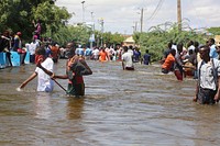 People wade through floods that submerged their neighborhood in Belet Weyne, Somalia, on 28 October 2019.