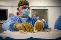 ATLANTIC OCEAN (Dec. 1, 2019) Hospital Corpsman 3rd Class Kyle Weaver, from Plant City, Florida, prepares to hand off surgical instruments during a surgery in a medical operating room aboard the Nimitz-class aircraft carrier USS Harry S. Truman (CVN 75) in the Atlantic Ocean Dec. 1, 2019.