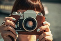 Girl holding vintage camera. Free public domain CC0 image.