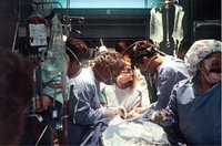 Retired Vietnam era surgeon CAPT Richard Virgilio, USN (2nd from left) leads the way through emergency tracheostomy procedure with LCDR Gary Schwendig, MC, USN of Camp Pendleton.