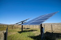 Solar panels at Sauerbier Ranches LLC, where producer Dan Doornbos (vest) and son-in-law ranch operator Ryan Ellis, were able to implement brush management practices and install a solar-powered (photovoltaic) electric well pump and distribution system with the help of U.S. Department of Agriculture (USDA) Natural Resources and Conservation Service (NRCS) John Wagoner (cowboy hat), at Sweetwater Basin, in southwest Montana, on August 27, 2019.