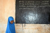 A grade one student reads a lesson on the blackboard at Mohamud Hilowle Primary and Secondary School during a class in Wadajir district, Mogadishu, Somalia on 12 January 2020. AMISOM Photo / Ilyas Ahmed. Original public domain image from Flickr