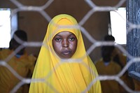 A grade 7 student photographed through a window at Mohamud Hilowle Primary and Secondary School during a class session in Wadajir district, Mogadishu, Somalia on 12 January 2020. AMISOM Photo / Ilyas Ahmed. Original public domain image from Flickr