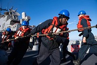 MEDITERRANEAN SEA (Jan. 10, 2020) &ndash; Operations Specialist 2nd Class Brandon Smalls, center, runs line aboard the Arleigh Burke-class guided-missile destroyer USS Ross (DDG 71) during a replenishment-at-sea, Jan. 10, 2019.