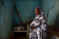 Zeinabou Karidou, a presenter at Radio Baarou, listens to a live round table broadcast in Radio Baarou’s office in Ouallam, Niger. Credit: USAID. Original public domain image from Flickr