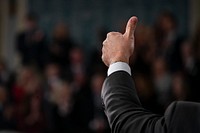 A member of Congress gives the thumbs-up, in the House chamber at the U.S. Capitol in Washington, D.C. Original public domain image from Flickr